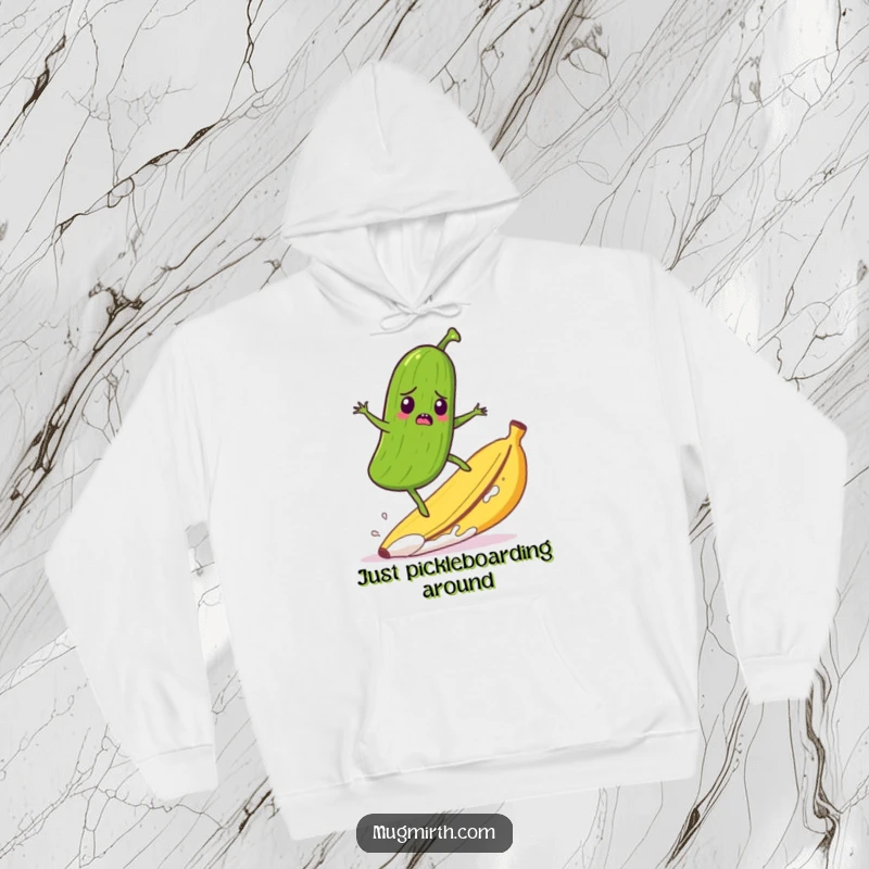 Funny hoodie design with a startled pickle comically surfing a runaway banana peel, ideal for casual, humorous wear.